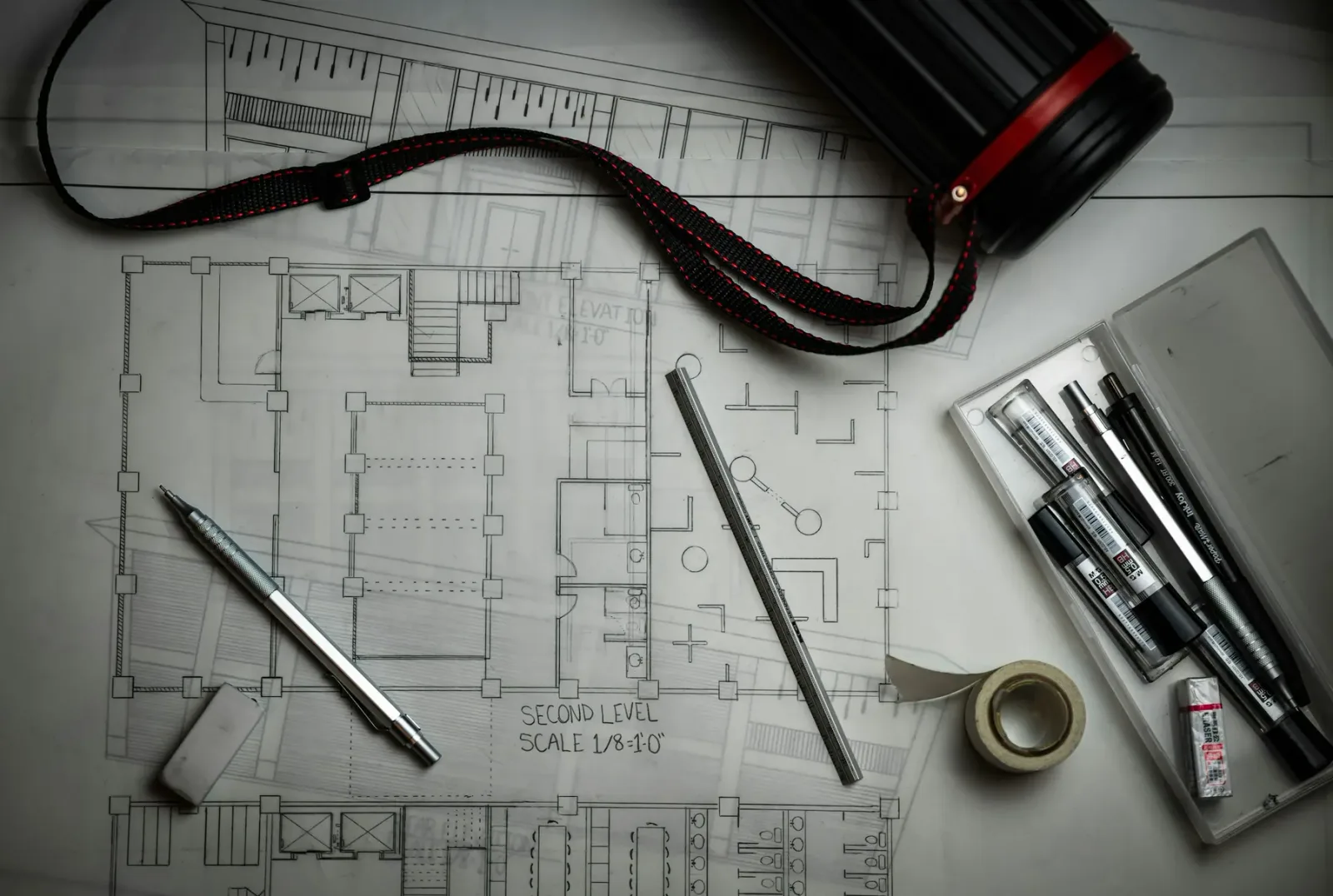 Architectural drawings and tools illustrating construction and design