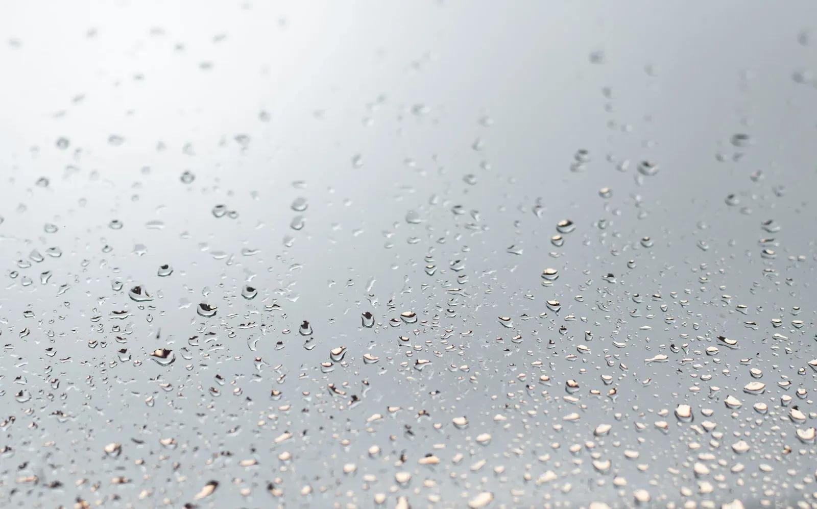 Clear water droplets on glass